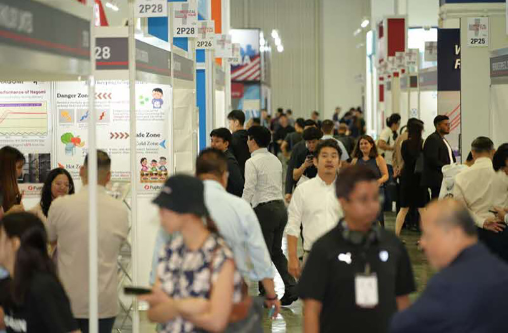 A lively exhibition with attendees exploring medical innovations and product displays.